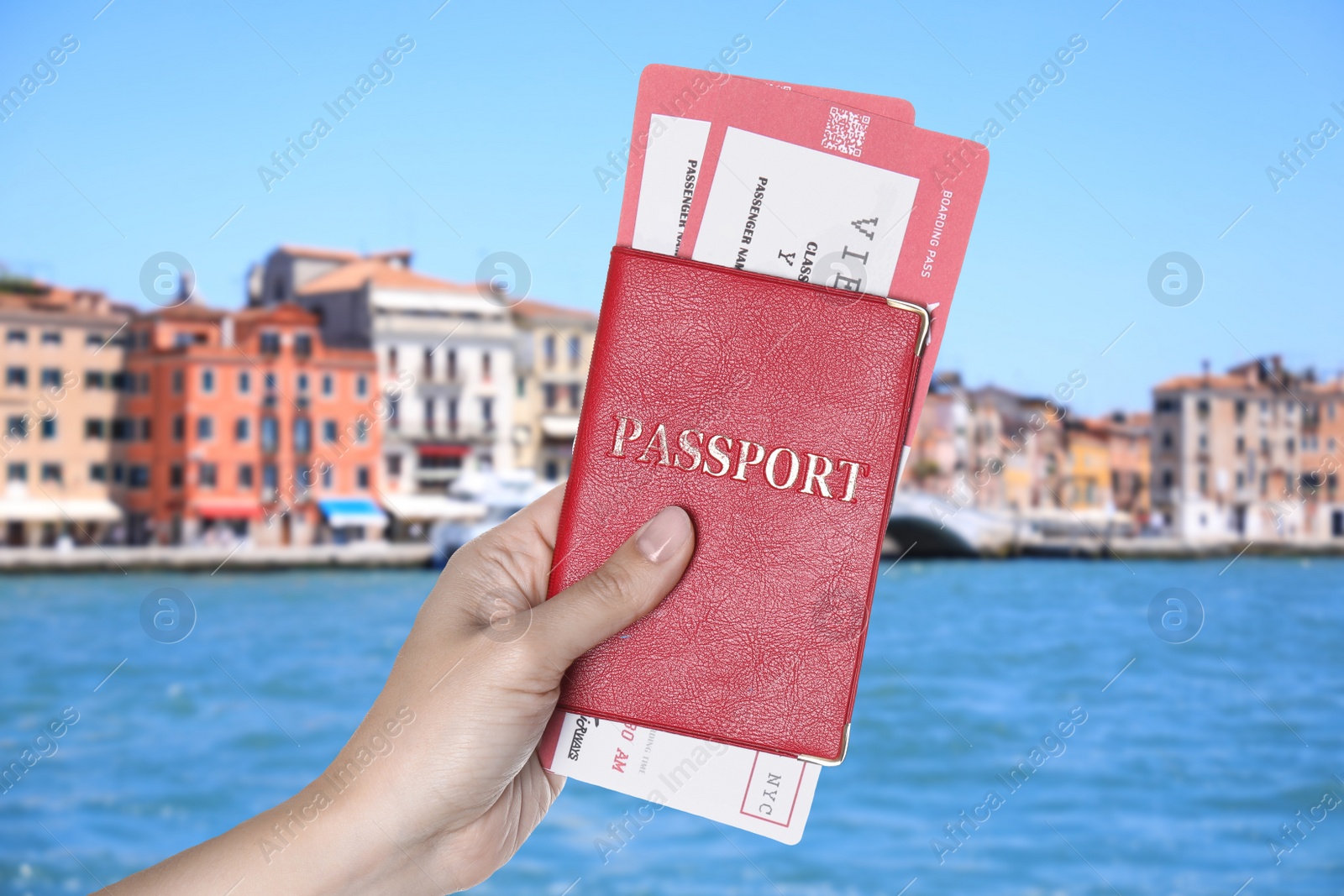 Image of Woman holding passport with tickets and beautiful view of city near sea on background