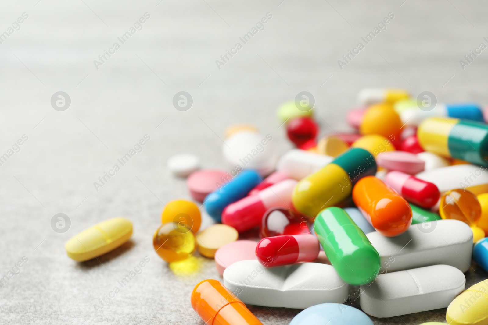 Photo of Heap of different pills on table, closeup. Space for text