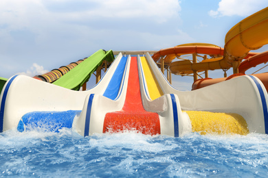 Photo of Colorful slides at water park. Summer vacation