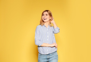 Portrait of emotional woman posing on color background