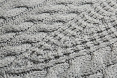 Photo of Grey knitted fabric with beautiful pattern as background, closeup