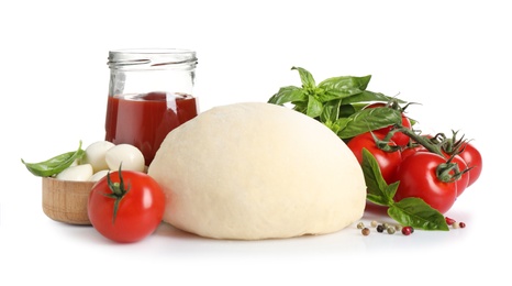 Fresh dough and ingredients for pizza on white background