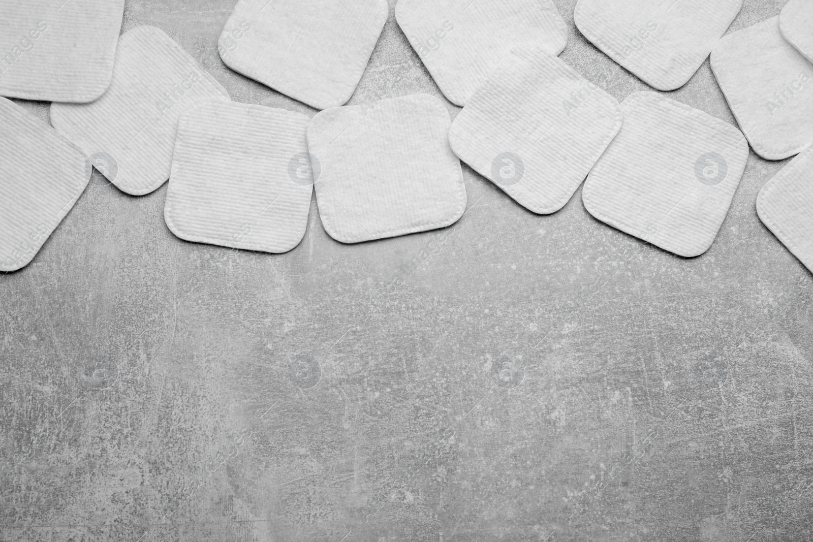 Photo of Many clean cotton pads on light grey background, flat lay. Space for text