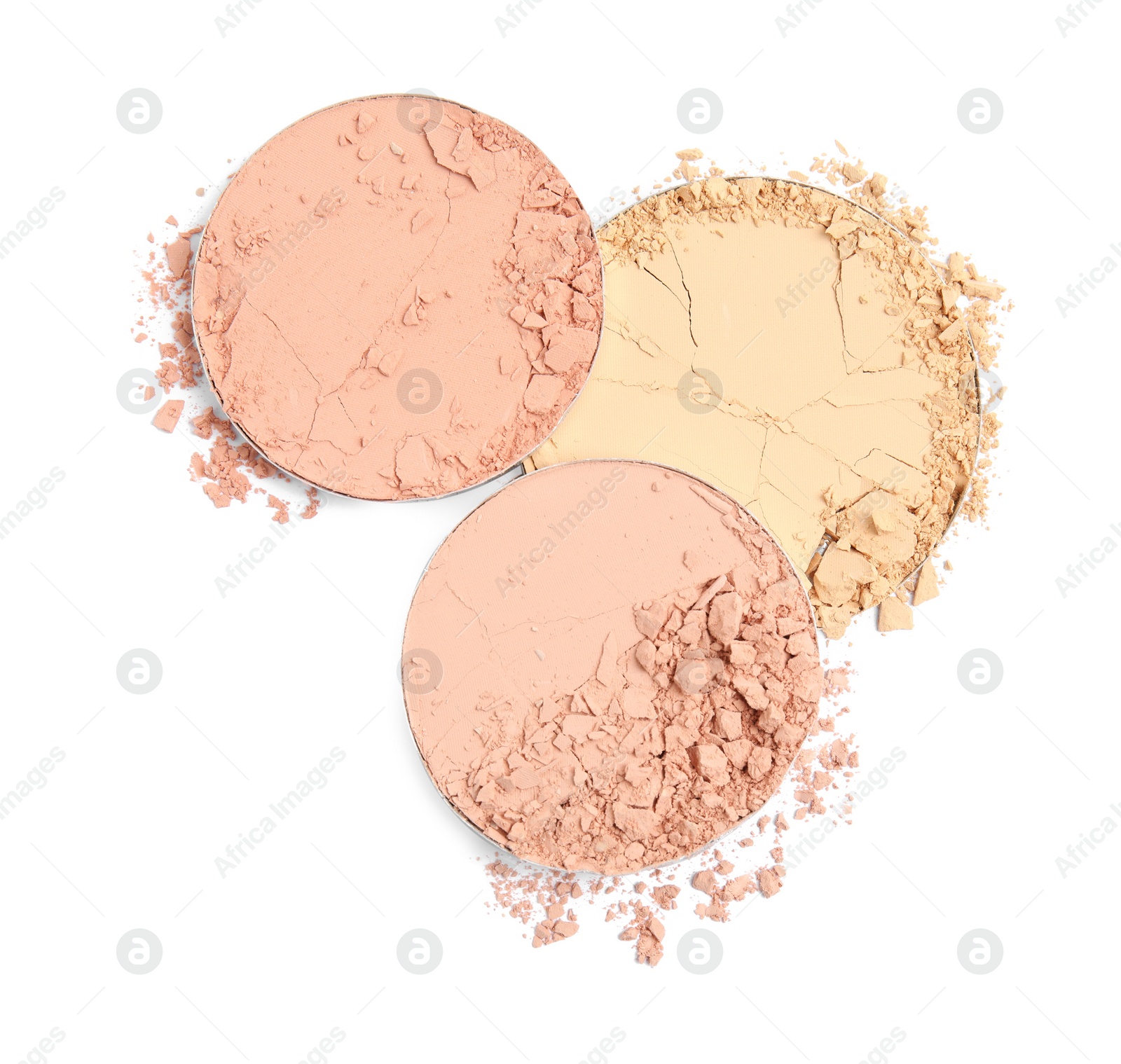 Photo of Different broken face powders on white background, top view