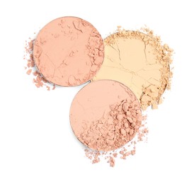 Photo of Different broken face powders on white background, top view