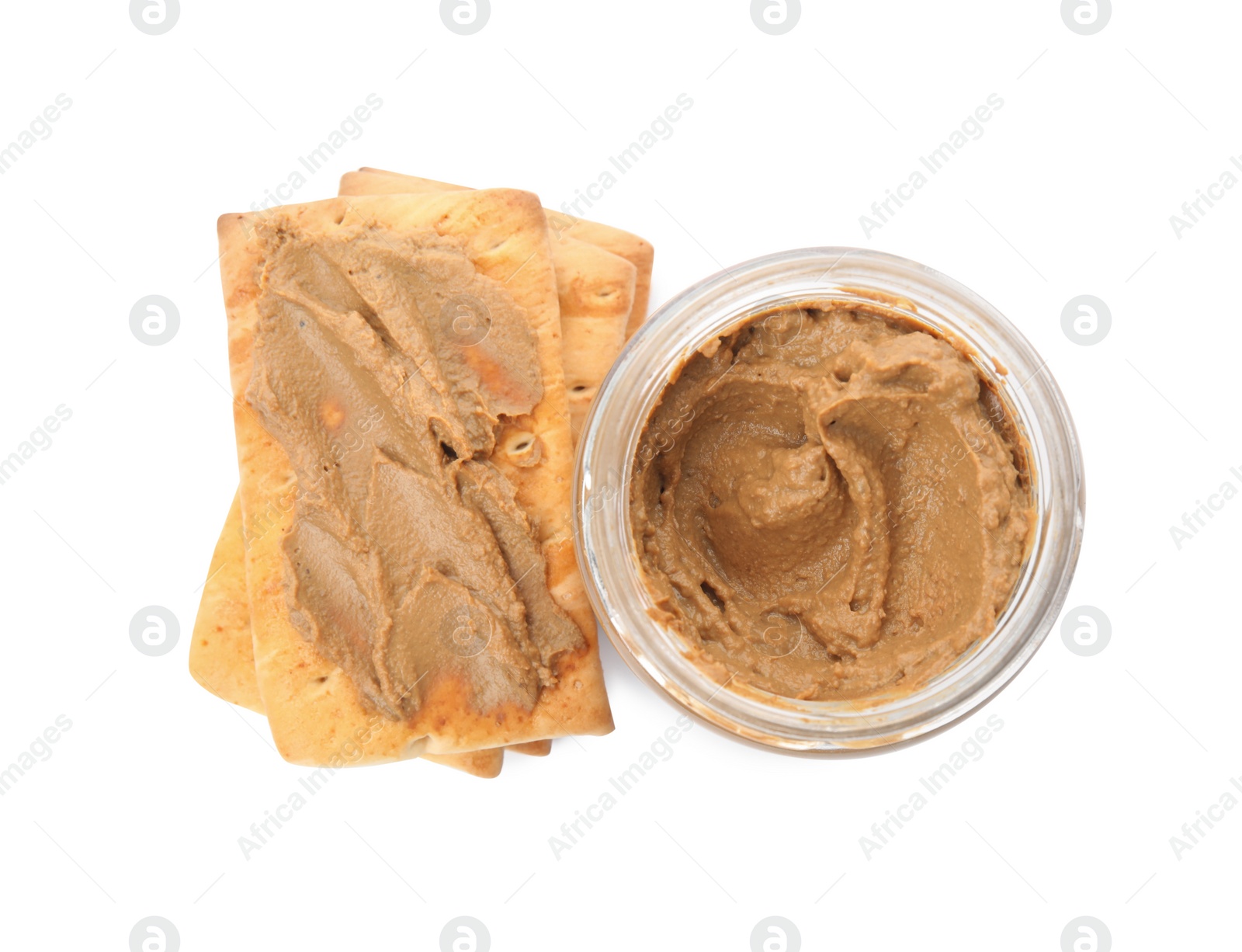 Photo of Crispy crackers and delicious meat pate on white background, top view