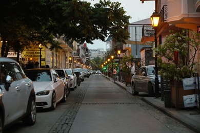 Photo of BATUMI, GEORGIA - MAY 31, 2022: Beautiful city street with buildings and parked cars in evening