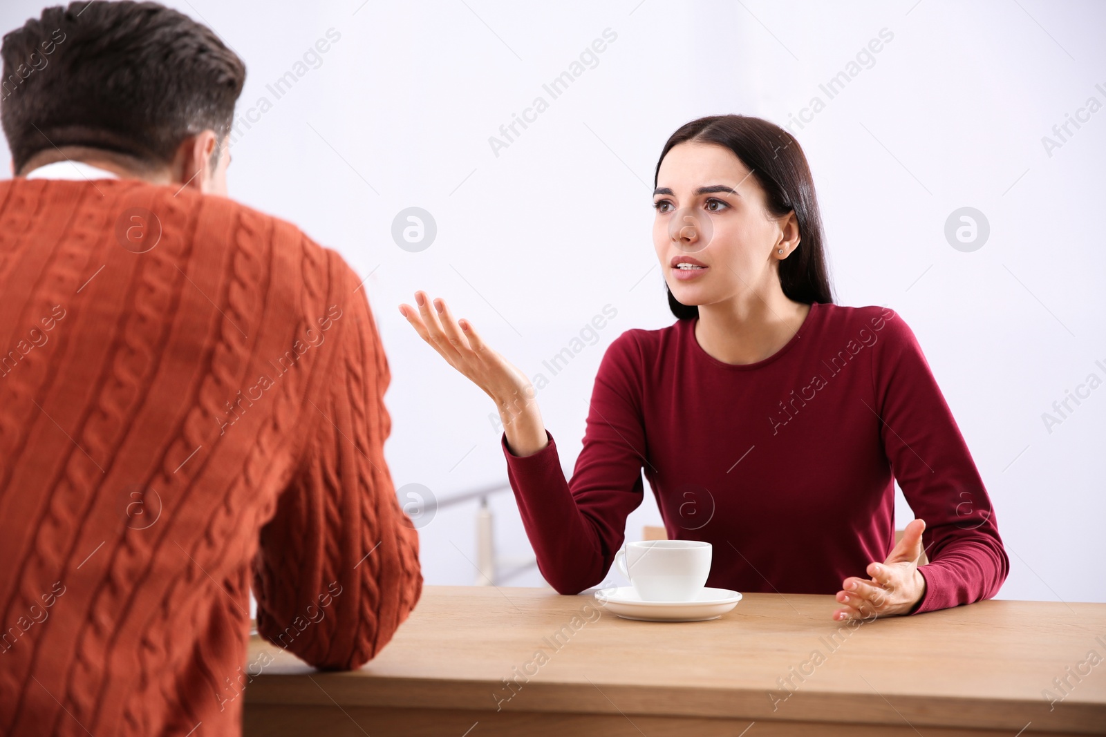 Photo of Couple having quarrel in cafe. Relationship problems