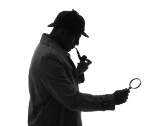 Photo of Old fashioned detective with smoking pipe and magnifying glass on white background
