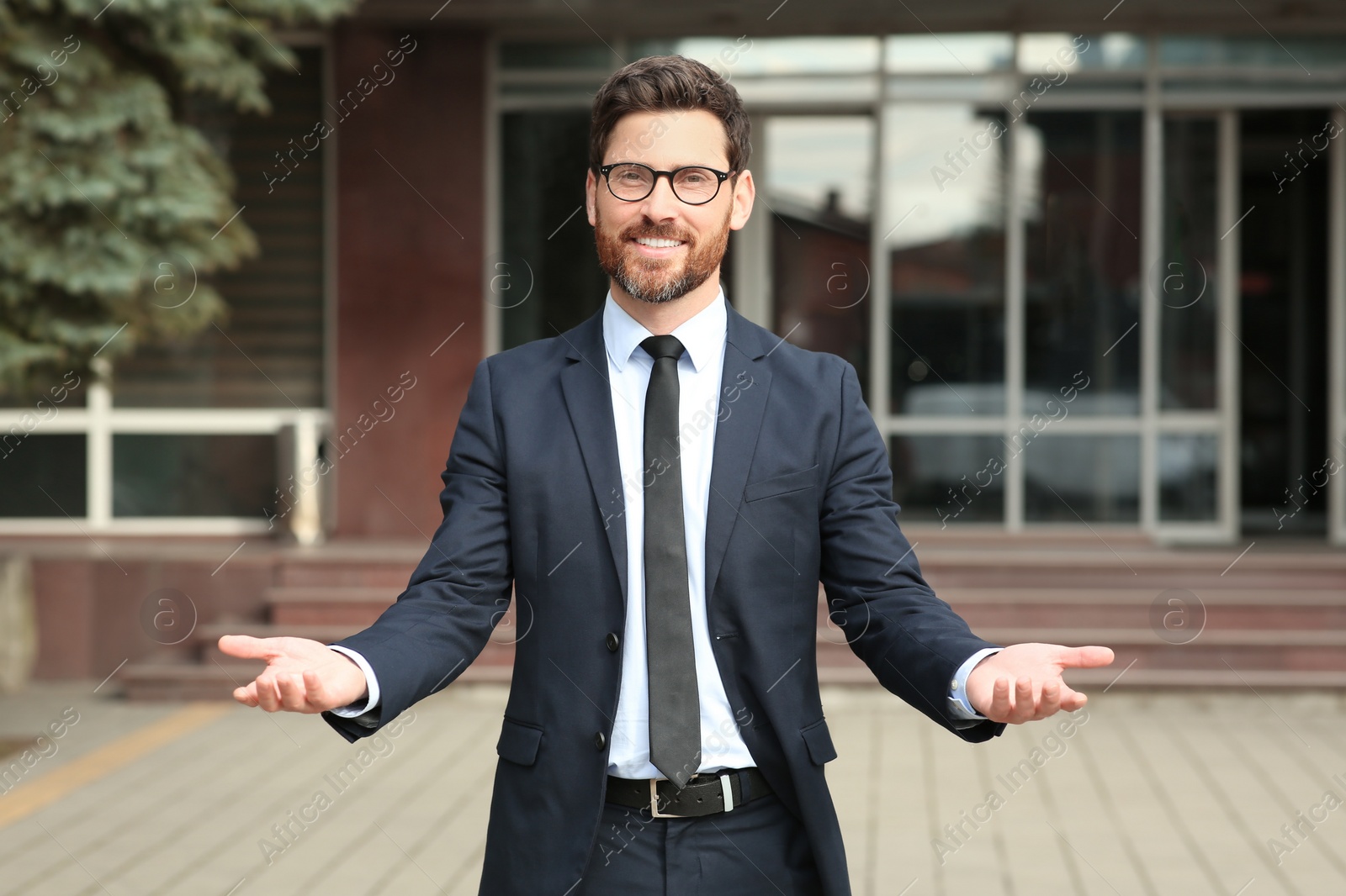 Photo of Handsome real estate agent in nice suit outdoors