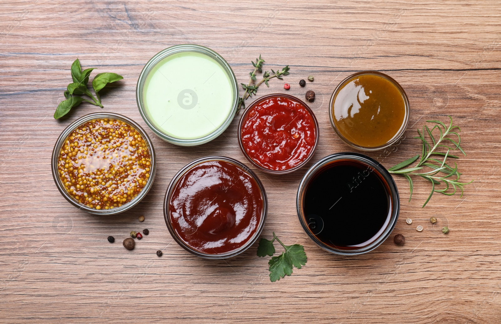 Photo of Many different sauces on wooden table, flat lay