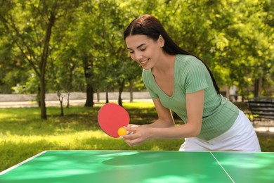 Photo of Young woman playing ping pong in park