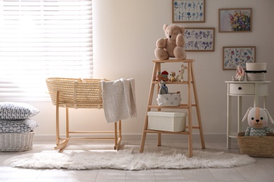 Decorative ladder with toys and different stuff in stylish baby room. Idea for interior design