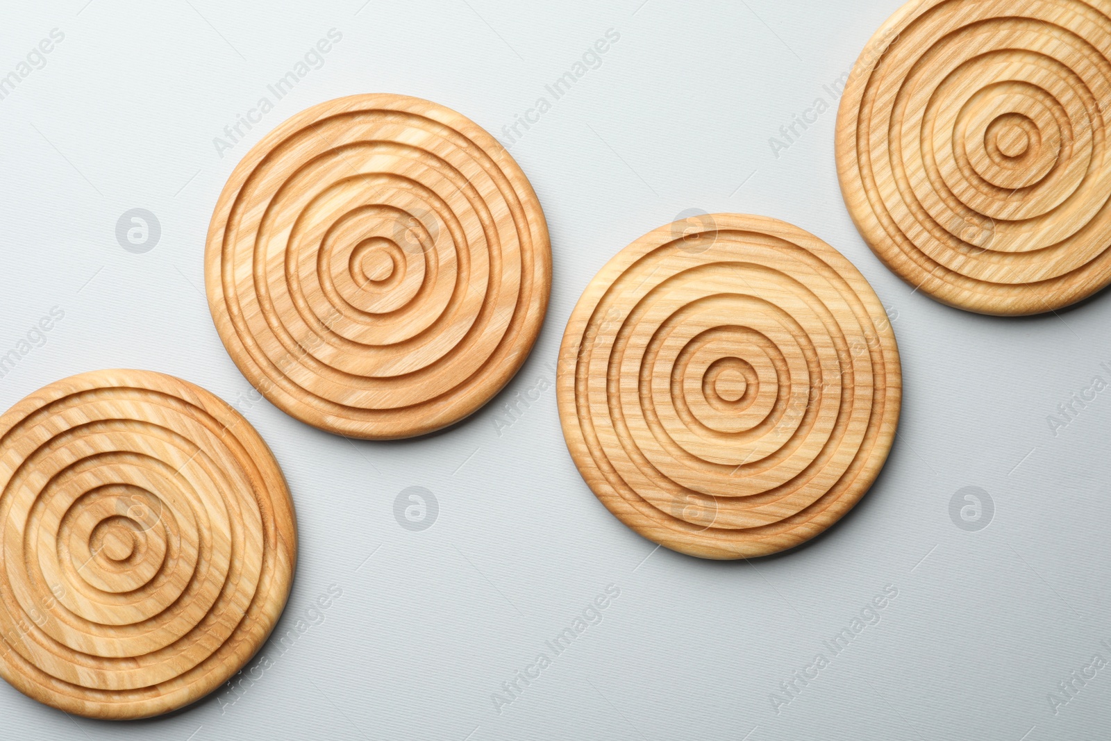 Photo of Stylish wooden cup coasters on light background, flat lay