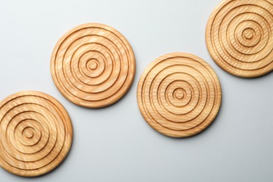 Photo of Stylish wooden cup coasters on light background, flat lay