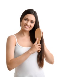 Photo of Beautiful smiling young woman with hair brush on white background