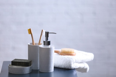 Photo of Aromatic soap and toiletries on table against blurred background. Space for text