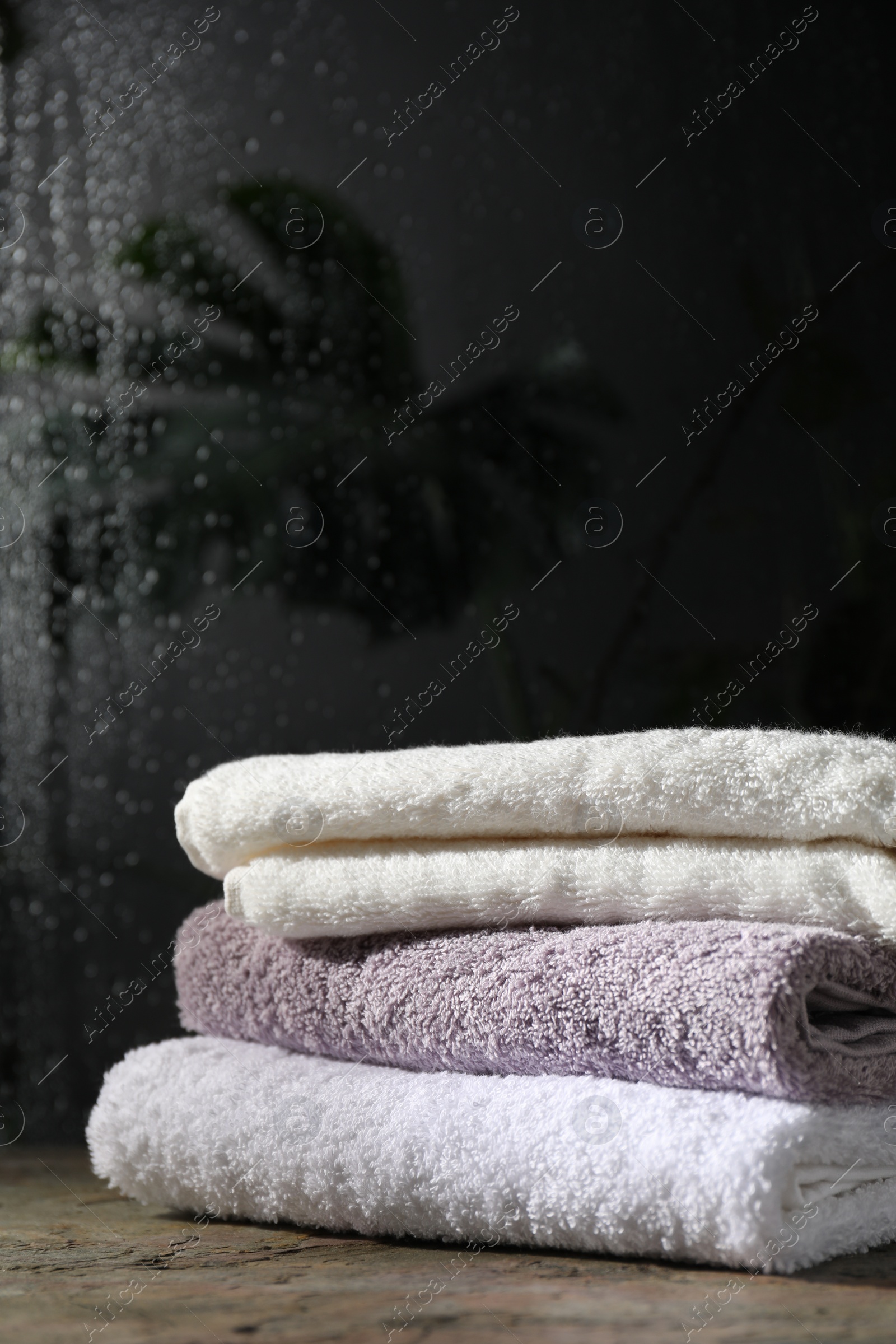 Photo of Stacked terry towels on table in bathroom