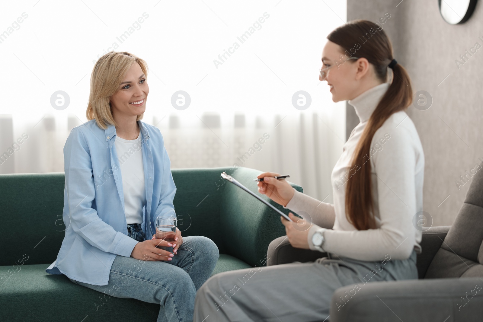 Photo of Professional psychotherapist working with patient in office