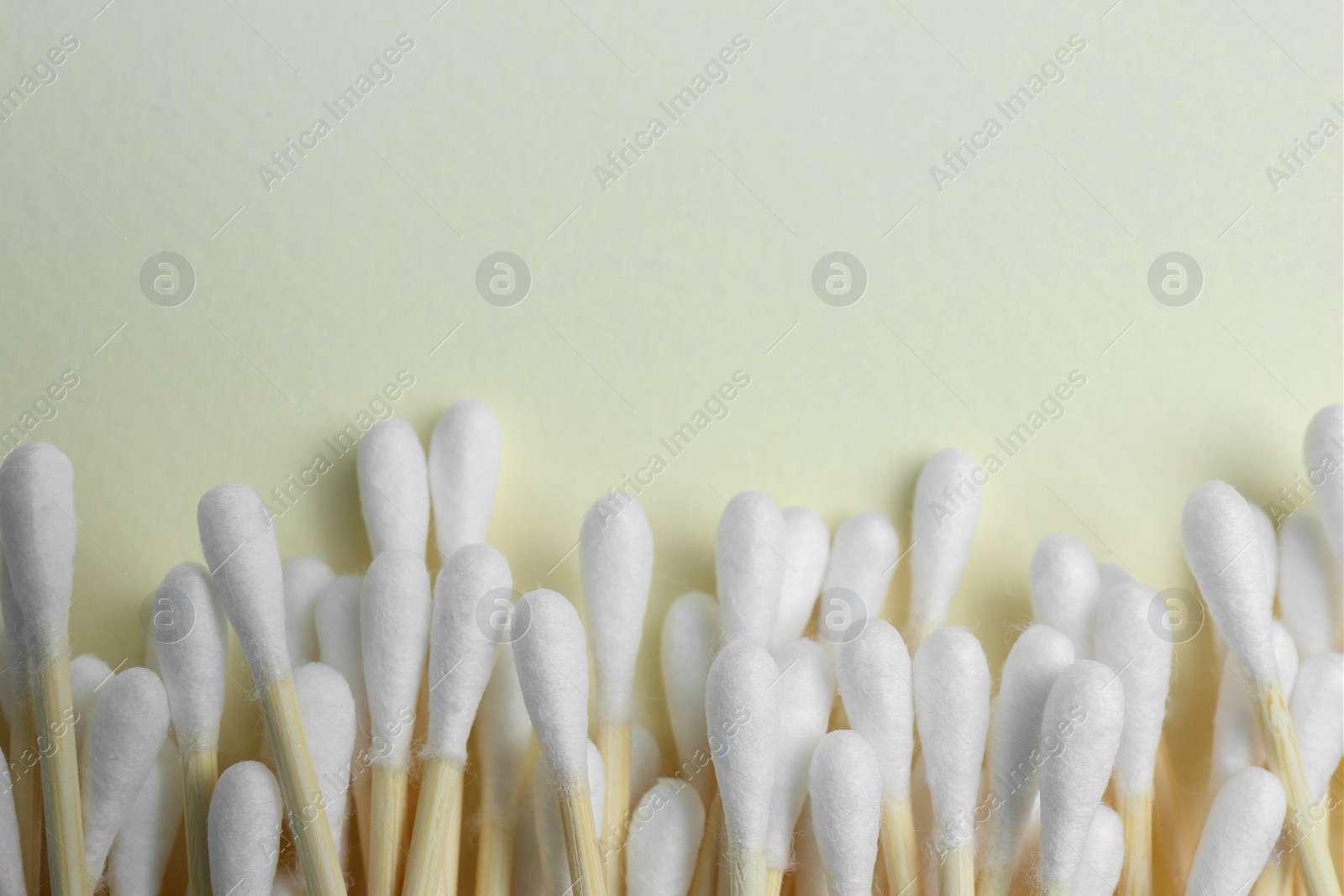 Photo of Many cotton buds on beige background, flat lay. Space for text