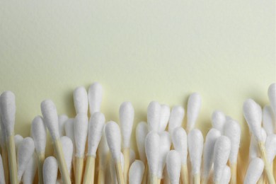 Photo of Many cotton buds on beige background, flat lay. Space for text
