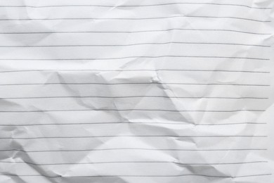 Photo of Crumpled lined notebook sheet as background, top view