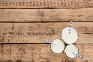 Photo of Glasses of milk on wooden table. Fresh dairy product