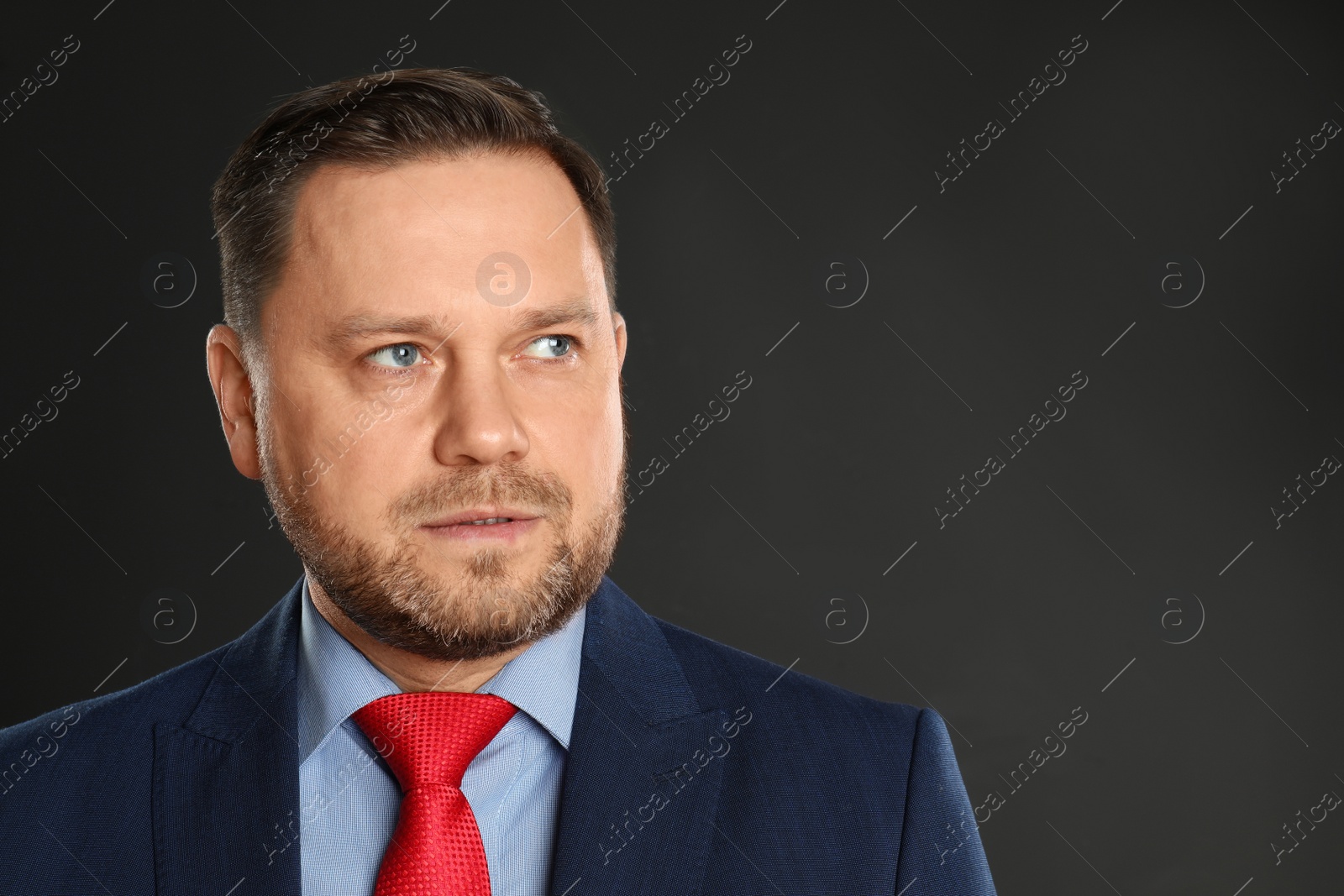 Photo of Portrait of mature man on black background