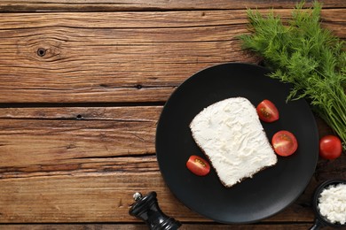 Delicious bruschetta with ricotta cheese, tomatoes and dill on wooden table, flat lay. Space for text