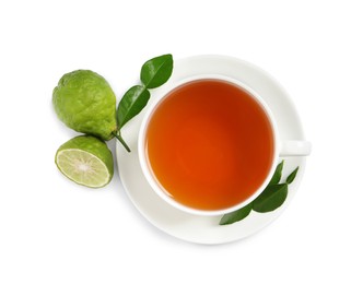 Cup of tasty bergamot tea and fresh fruits on white background, top view