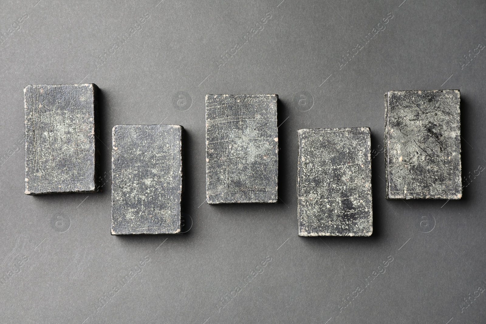 Photo of Natural tar soap on black table, flat lay