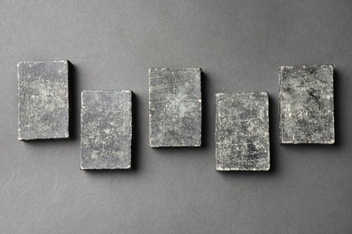 Photo of Natural tar soap on black table, flat lay