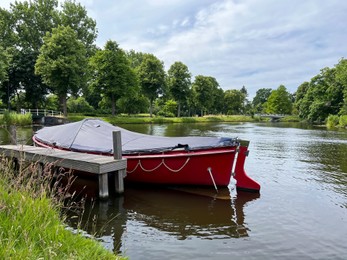 Photo of Beautiful view of canal with moored boat on sunny day