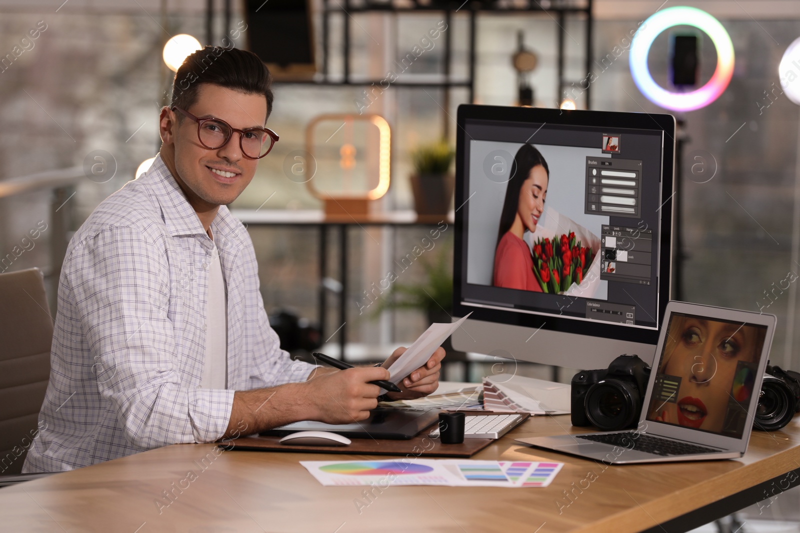 Photo of Professional retoucher working on computer in office