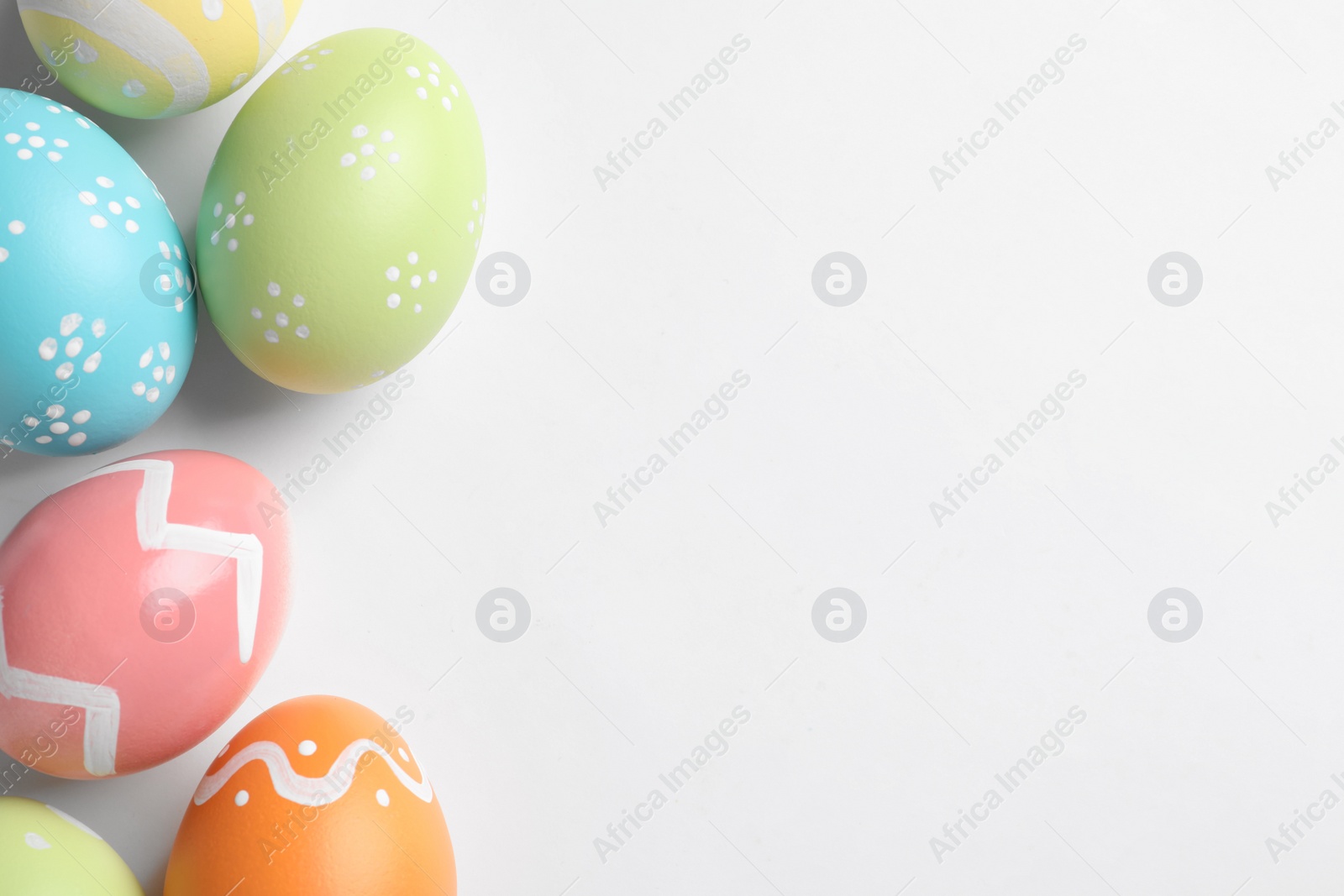 Photo of Beautiful painted Easter eggs on white background, top view