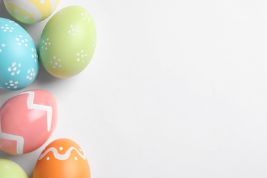 Beautiful painted Easter eggs on white background, top view