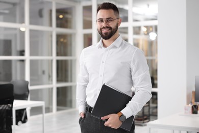 Photo of Portrait of smiling man with folder in office. Lawyer, businessman, accountant or manager