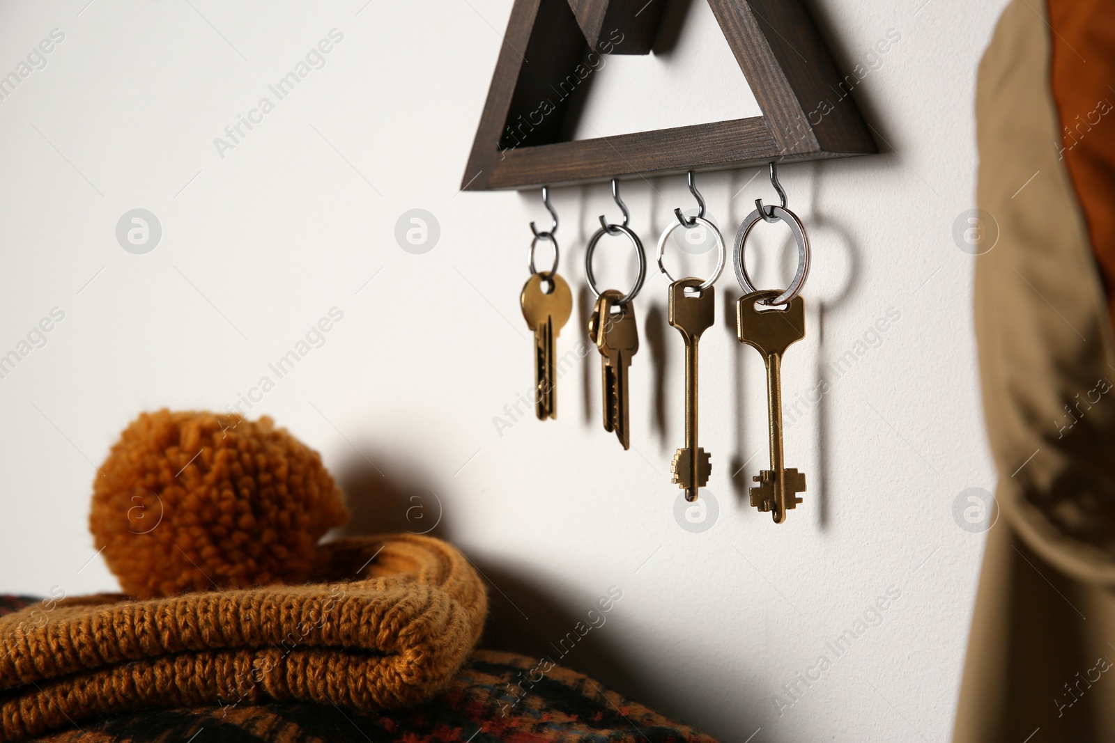 Photo of Wooden key holder on light wall indoors