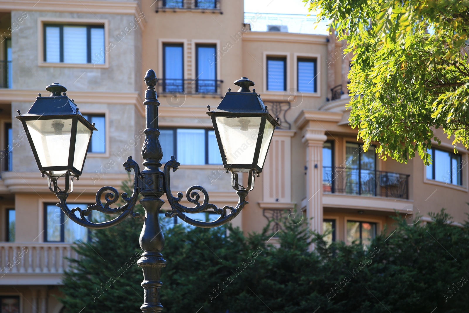 Photo of Beautiful vintage street lamps near building outdoors