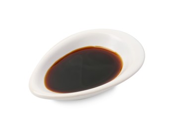 Photo of Tasty soy sauce in gravy boat isolated on white