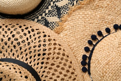 Photo of Many different straw hats as background, top view
