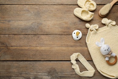 Photo of Cute baby stuff on wooden background, flat lay. Space for text