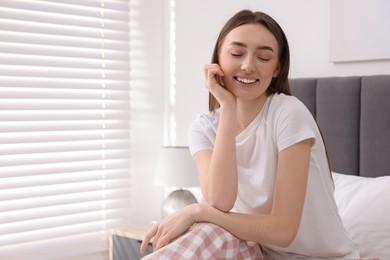 Photo of Portrait of beautiful woman laughing in bedroom. Space for text