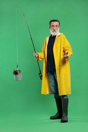 Fisherman with rod and tin can on green background