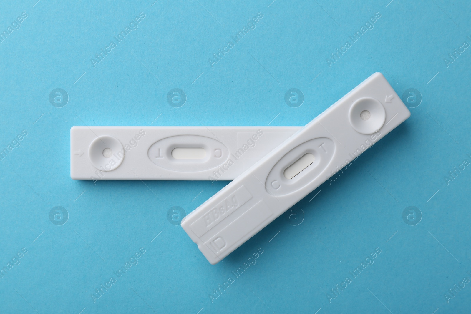 Photo of Disposable express tests on light blue background, top view