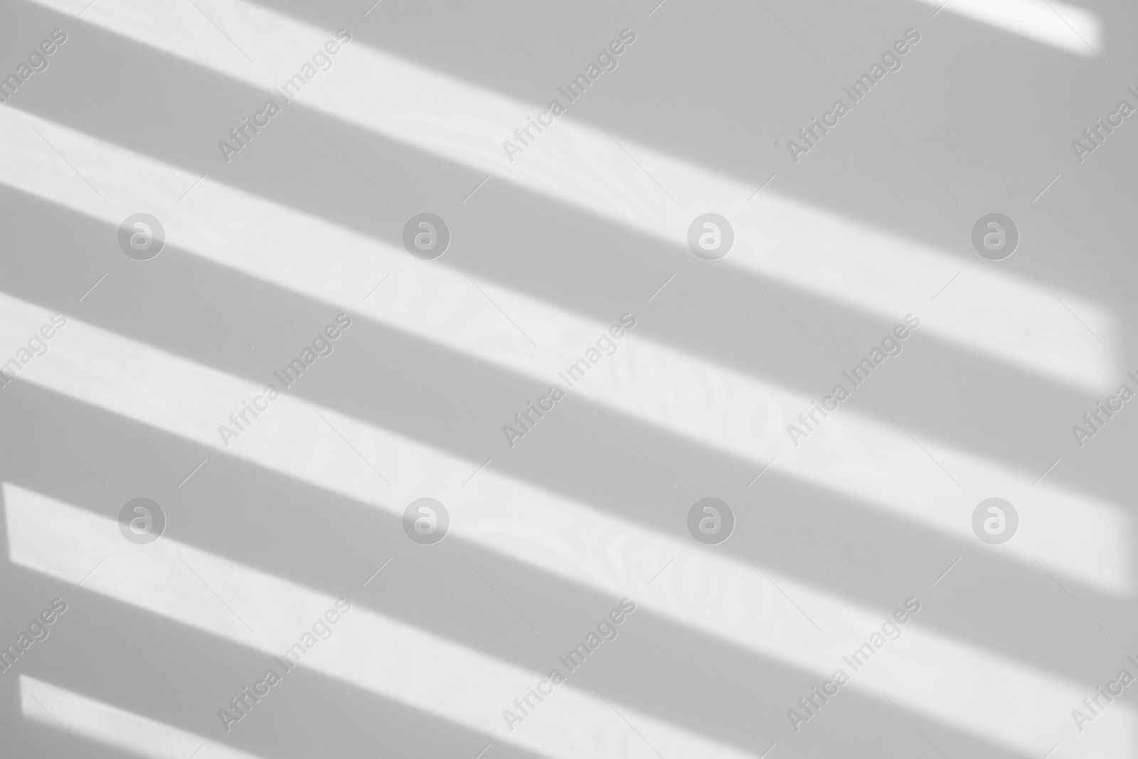 Image of Light and shadows falling on white wall