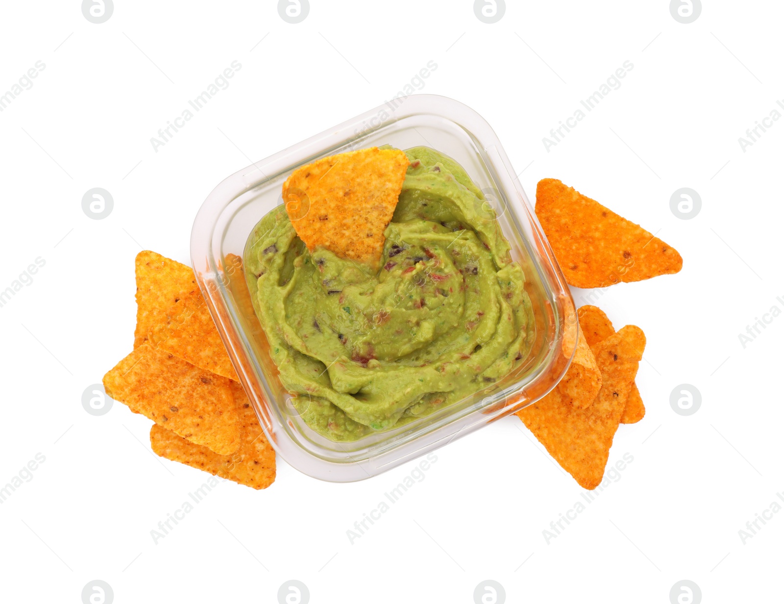 Photo of Bowl of delicious guacamole with nachos chips isolated on white, top view