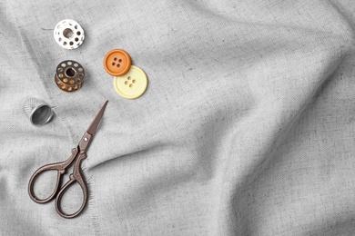 Photo of Composition with sewing accessories on fabric, top view