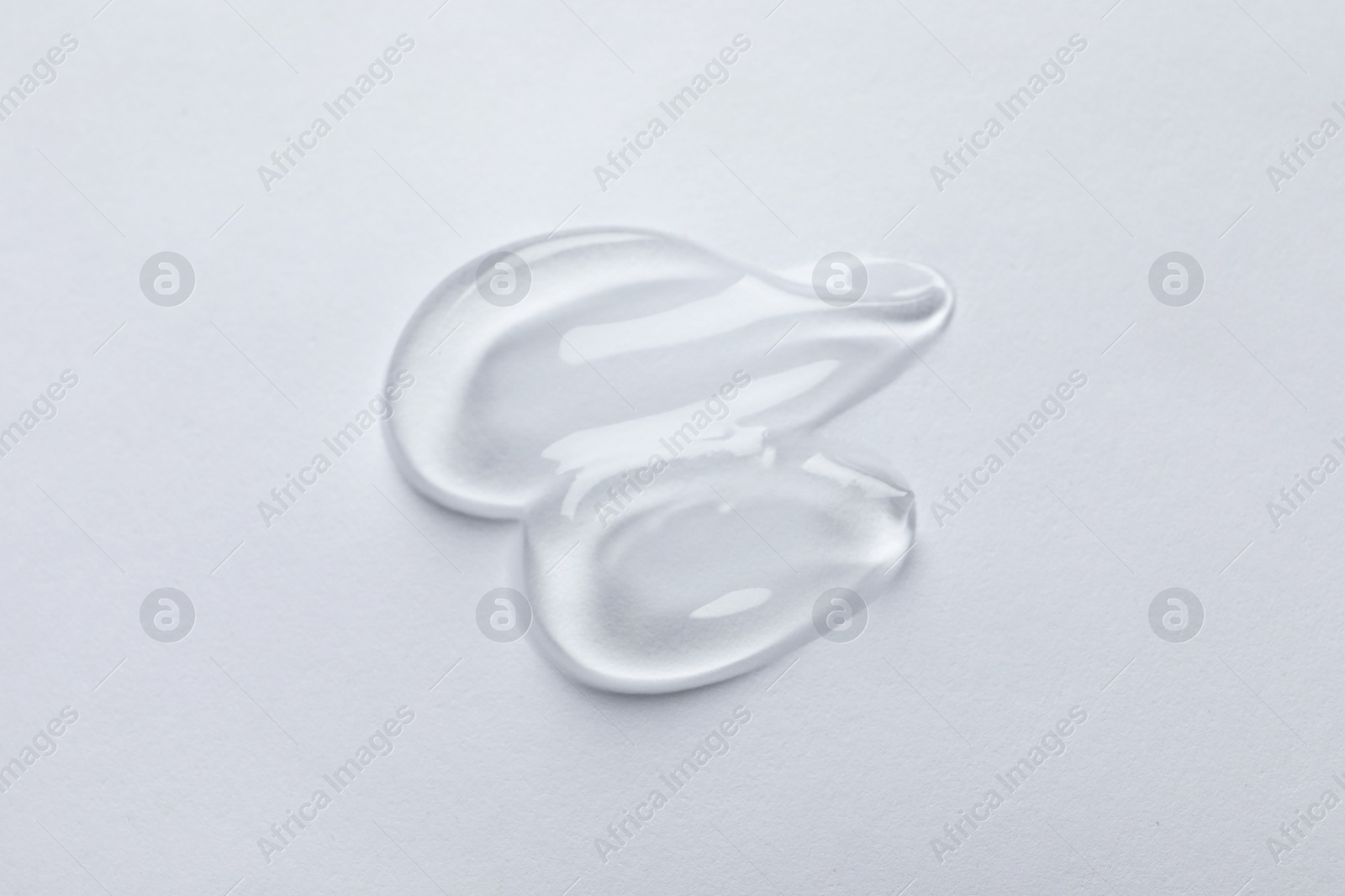 Photo of Swatches of cosmetic gel on white background, top view