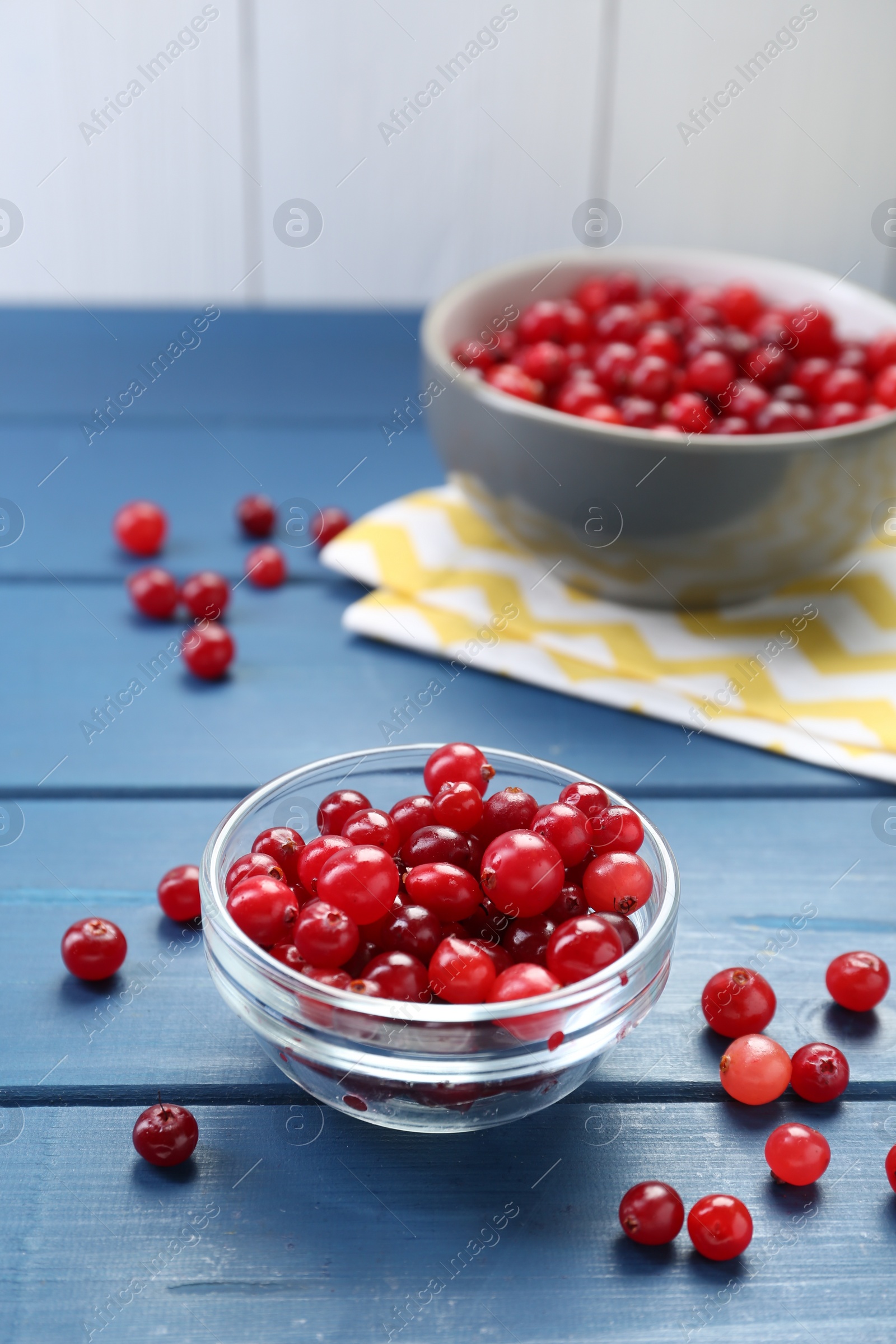 Photo of Fresh ripe cranberries on blue wooden table